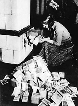 $Weimar-Republic-Lady-Using-Money-To-Heat-Home-1923.jpg