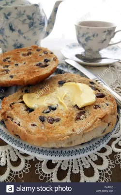 toasted-teacakes-a-traditional-british-cake-of-raisin-sultanas-and-DA229D.webp